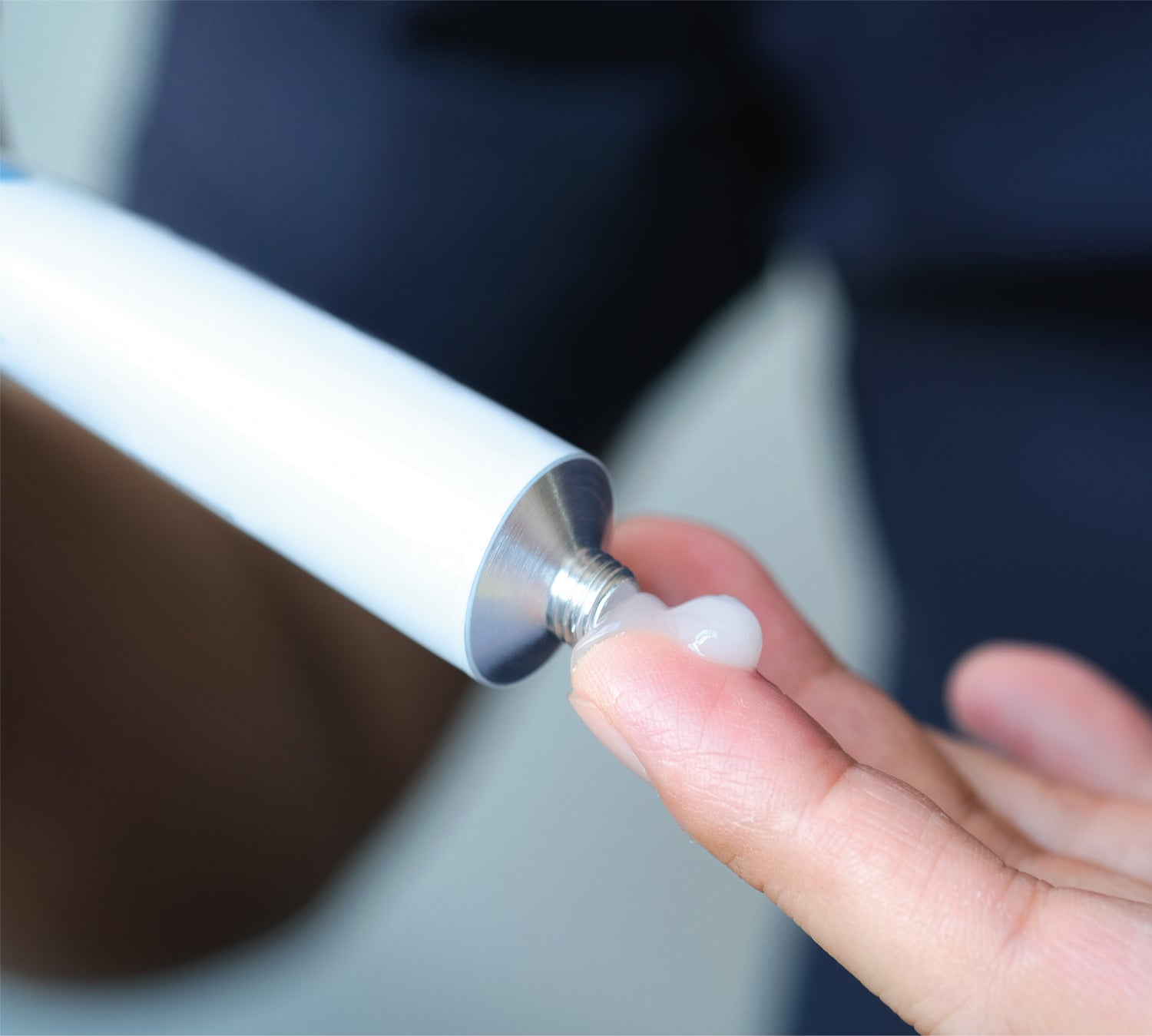 Person applying cream to finger